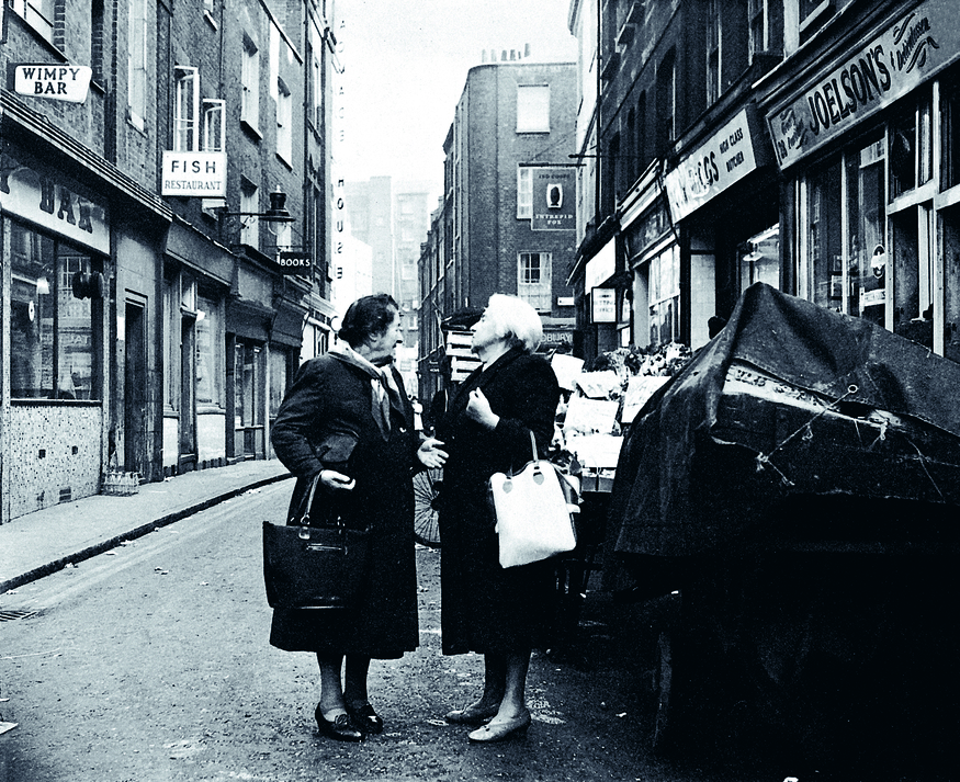 Two women gossiping in the street