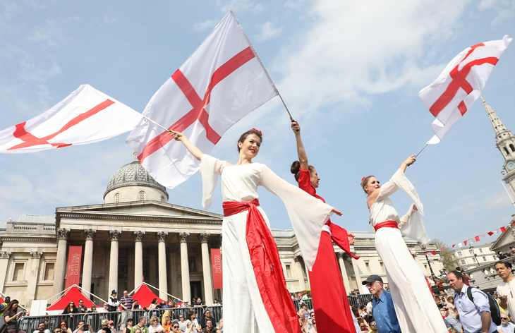 Stilt walkers with St George's flags