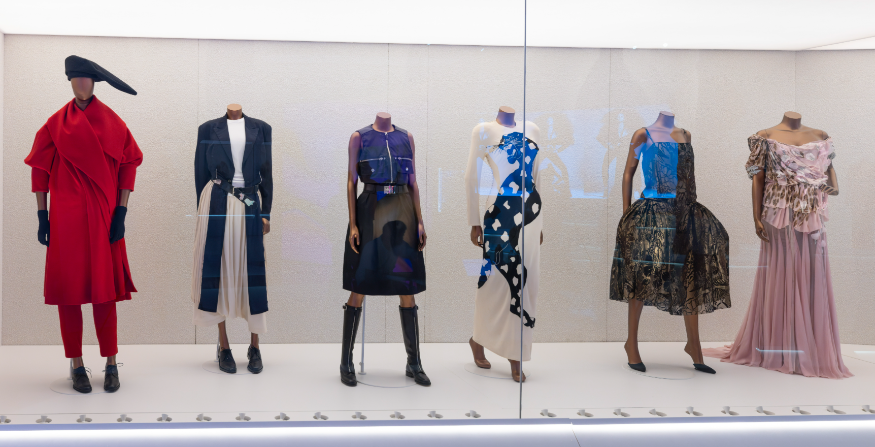 A museum display of six mannequins wearing various outfits