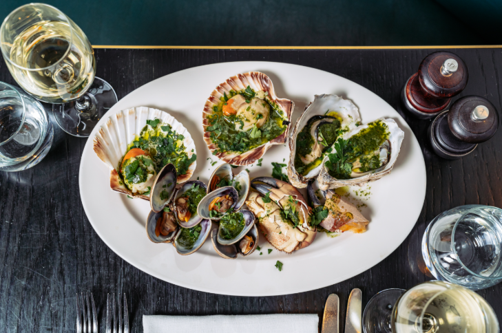 A plate of seafood, including mussels and crab