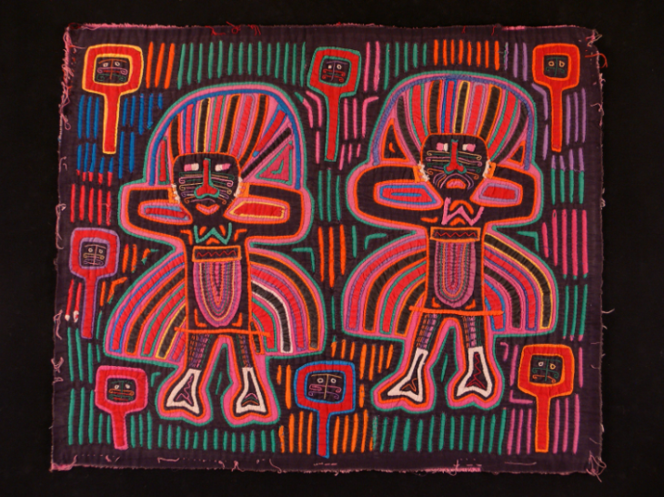 A textile artwork depicting two people