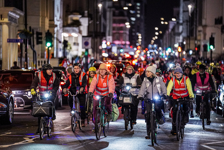 Lots of women cyclists in high-vis at night