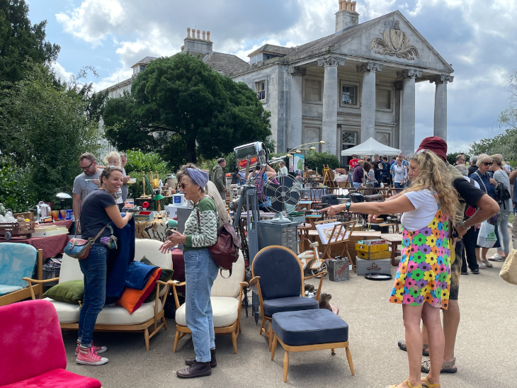 People looking at furniture at an outdoor vintage market