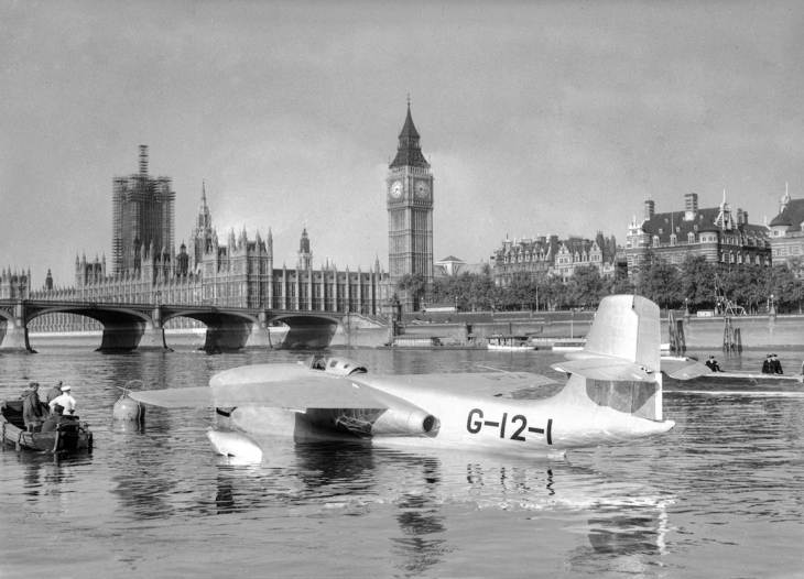 A plane on the water in front of Big Ben