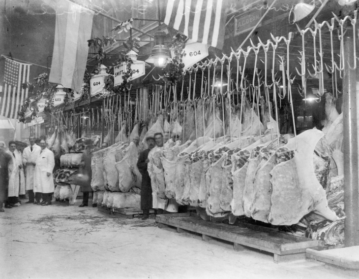 Butchers with sides of meat