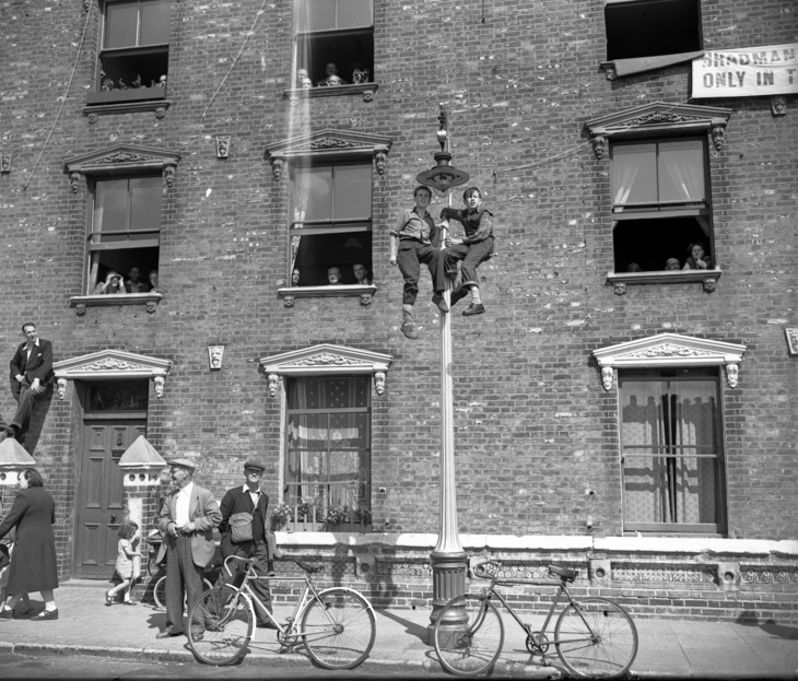Boys up a lamppost