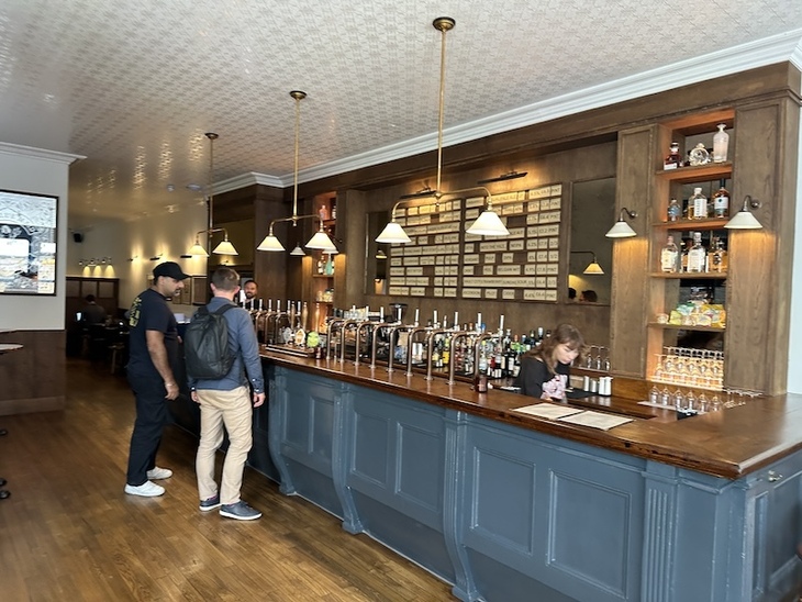 People standing at the Blue Maid bar