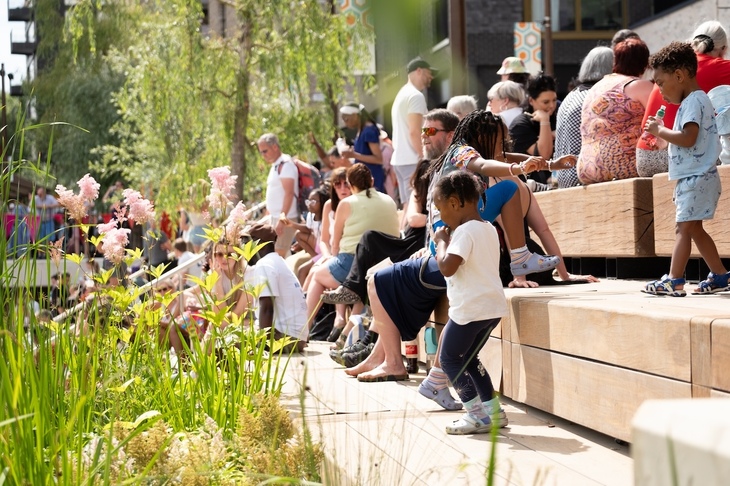 Families gathering on wooden steps outside