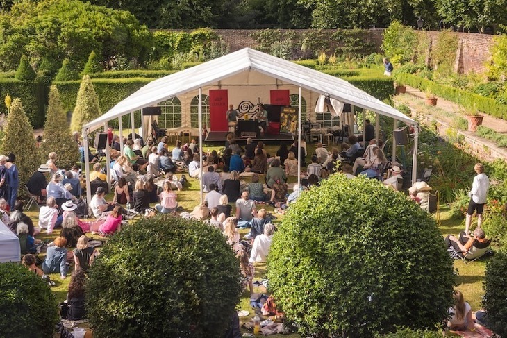 People watching an event at a gazebo