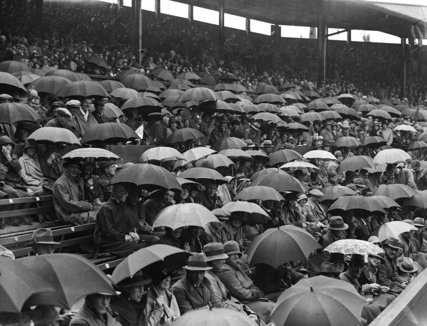 Wimbledon crowds with umbrellas up