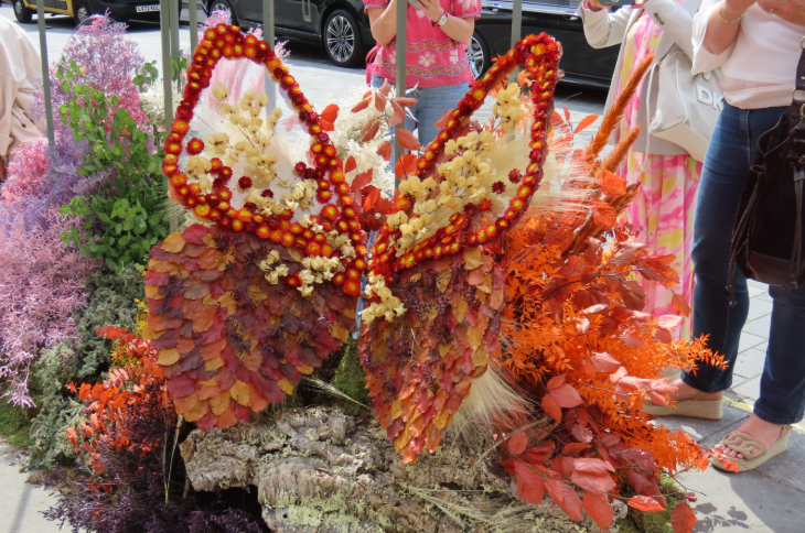 A large 3D butterfly made from orange and yellow flowers