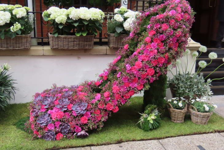 A giant high heeled shoe made from pink flowers