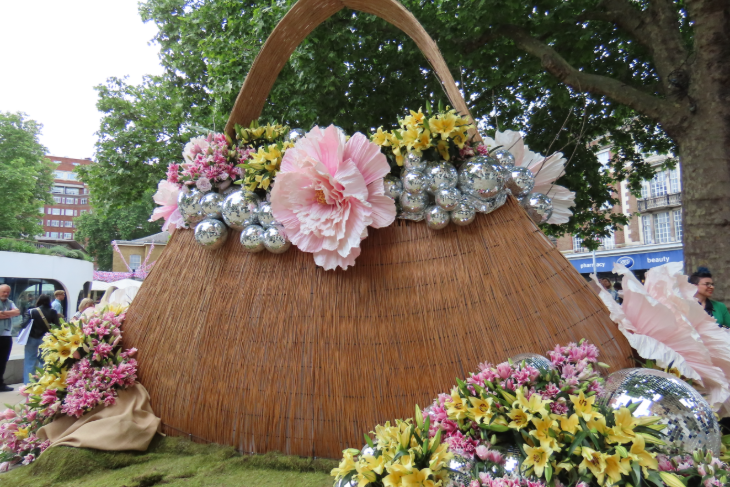 A giant wicker handbag, decorated with pink and yellow flowers, and disco balls, in Duke of York Square