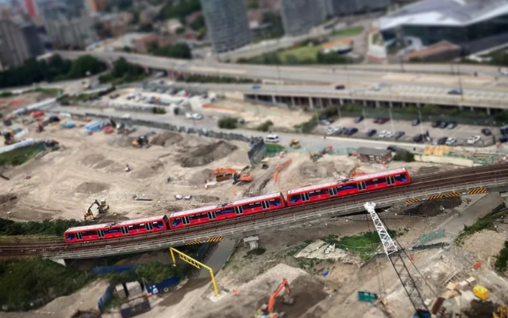 A DLR train wending through wasteland