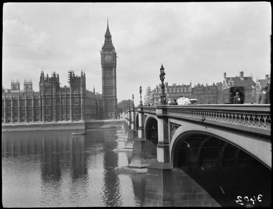 A black and white photo of Westminster Bridge and the Houses of Parliament
