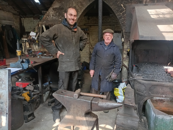 Two blacksmiths in the forge