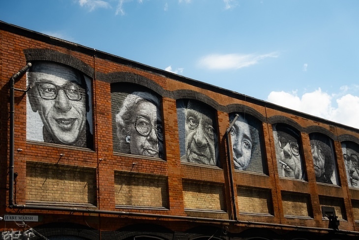 A rail viaduct with lots of faces on it 
