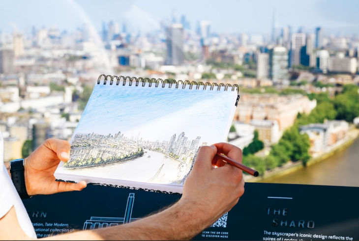 An artist sketching a recreation of the London skyline live