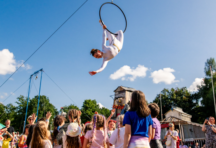 People watching an aerial acrobat performing