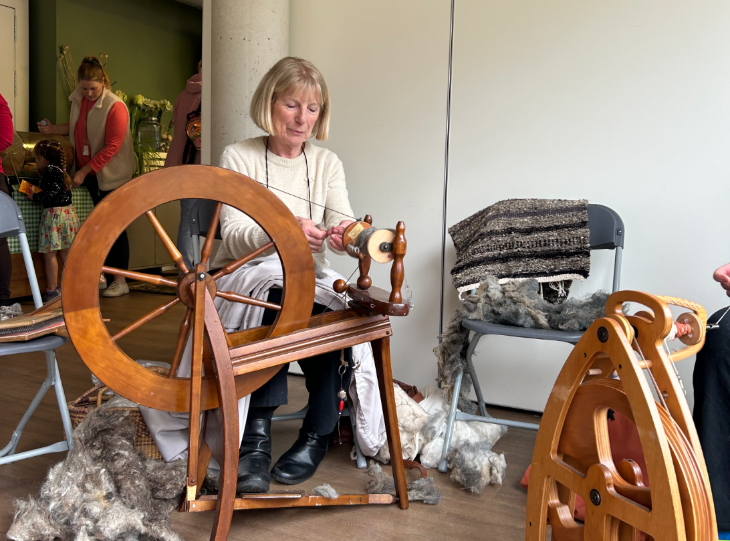A woman operating a spinning wheel