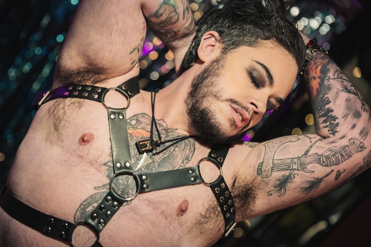 A boylesque performer in bondage gear