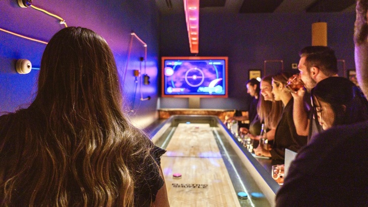 People playing shuffleboard