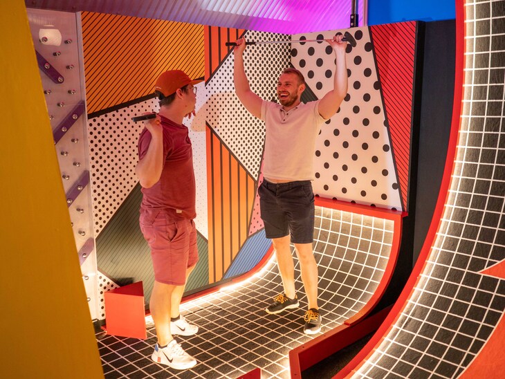 Two men playing crazy golf