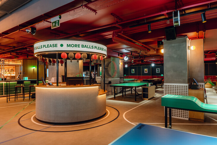 Ping pong tables and a kiosk saying 'new balls please'