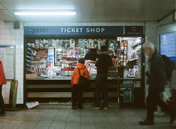 People buying tickets from an Underground kiosk