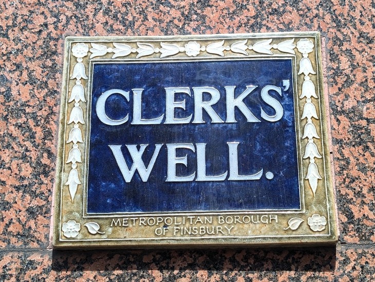 A blue sign: Clerks' Well