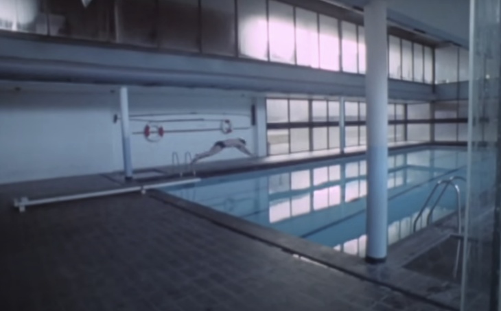 Someone diving into a pool