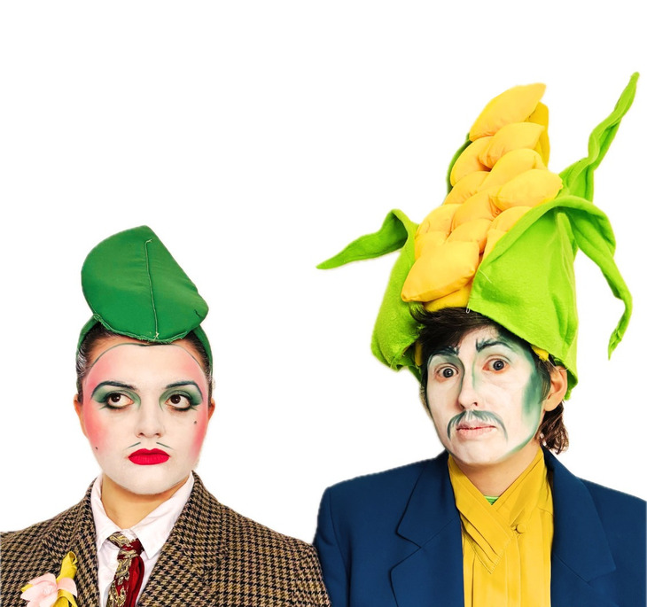 Two face painted actors dressed as sweetcorn