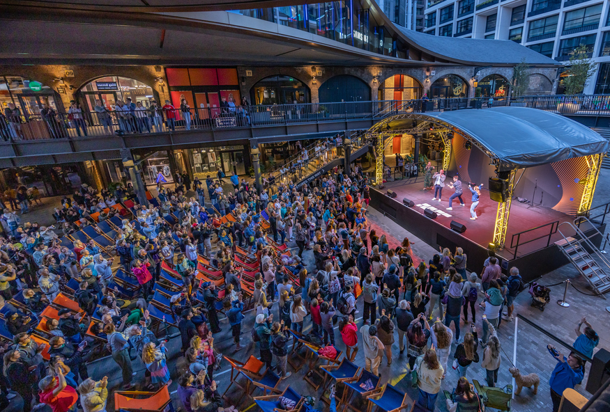 People dancing in front of a stage