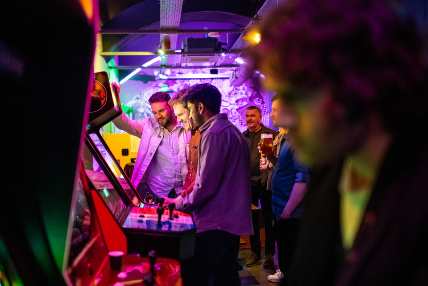 People playing on arcade games