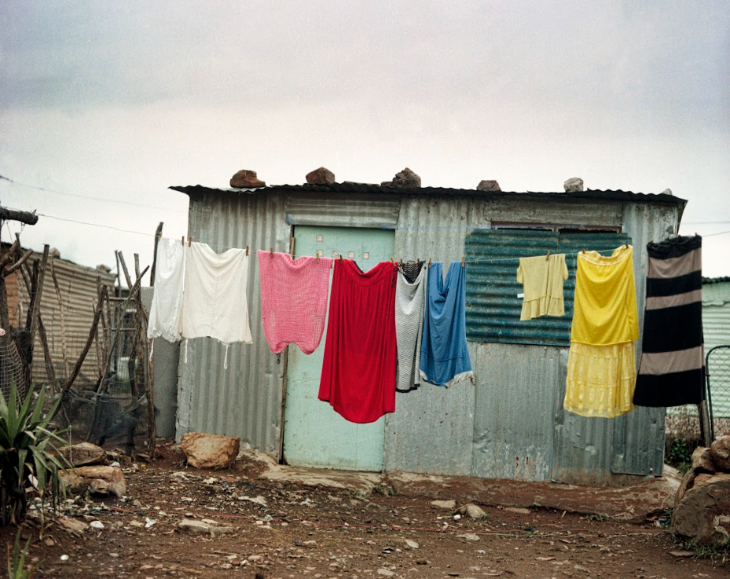 Colour photograph of a laundry line with
coloured clothes hung up on it.