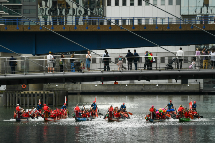 What's on in London July 2025: dragon boat racing beneath a pedestrian bridge in Canary Wharf