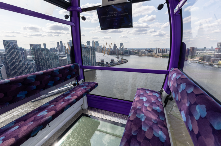 The interior of a cable car with a glass floor