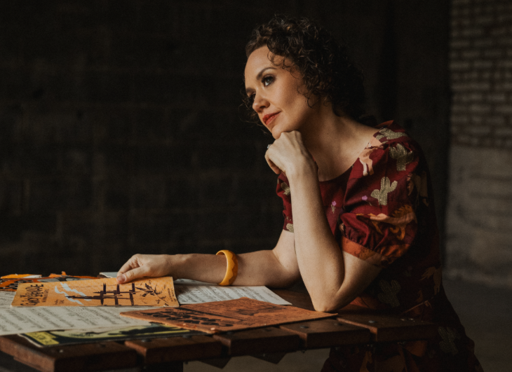 Hilary Gardner sitting at a table with sheet music in front of her