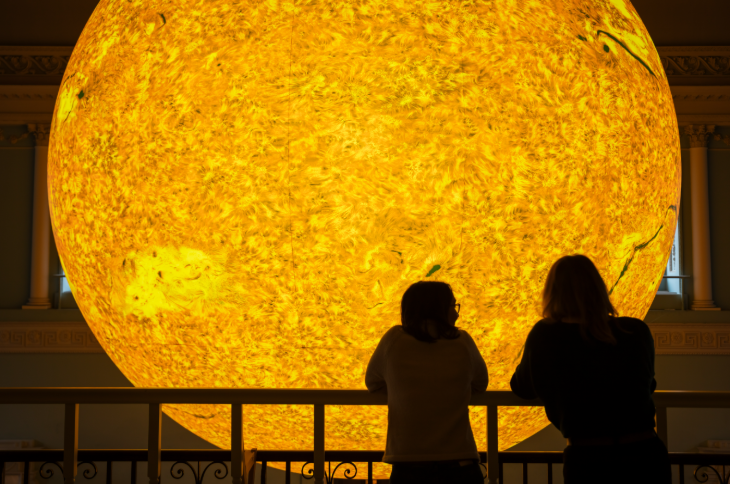 What's on in London July 2025: people silhouetted in front of a glowing model of the sun