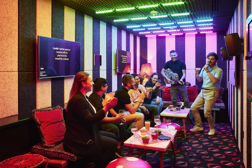 karaoke in London: People doing karaoke in a colourful room