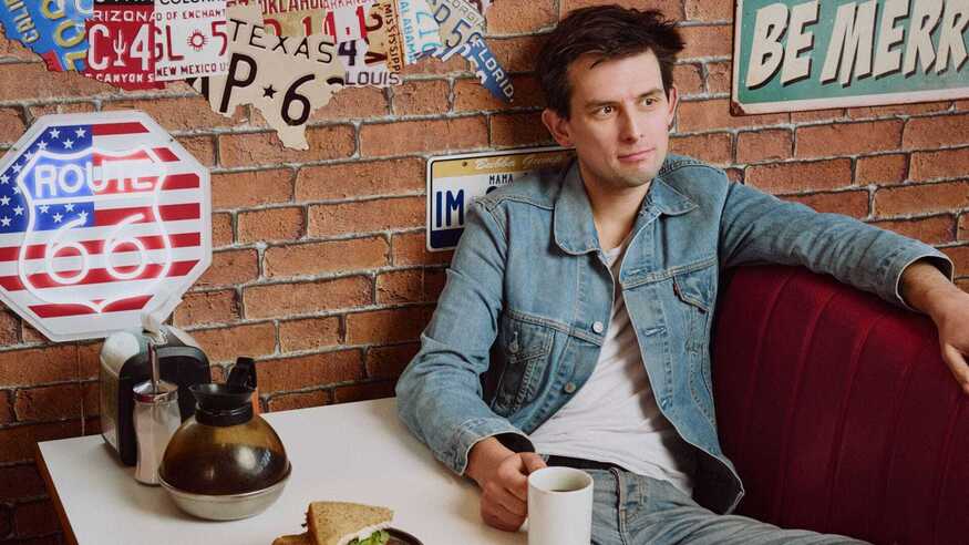 Kieran Hodgson surrounded by American paraphenalia