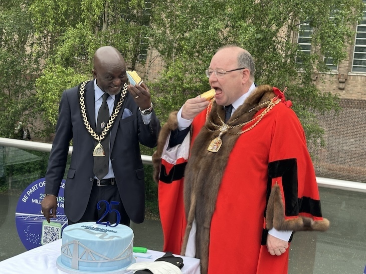 The Lord Mayor of London and the Mayor of Southwark stuffing cake into their faces