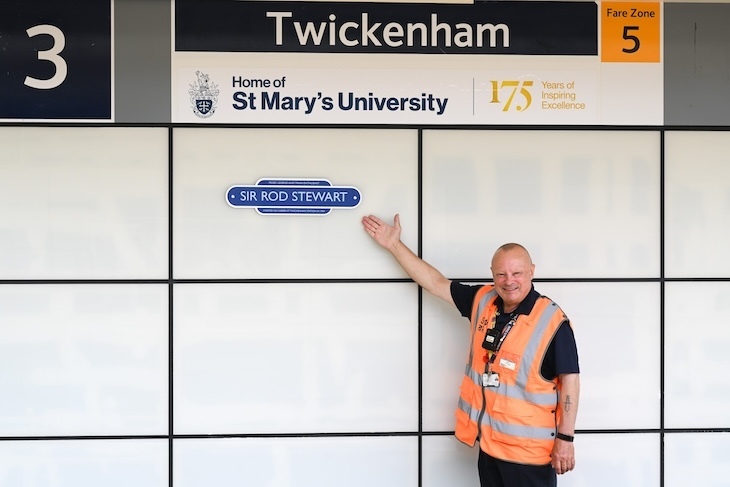 A man points to a plaque to rod stewart