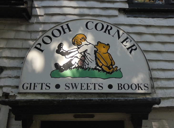 Summer holidays 2025 in London: Pooh Corner sign with an illustration of Christopher Robin and Winnie the Pooh