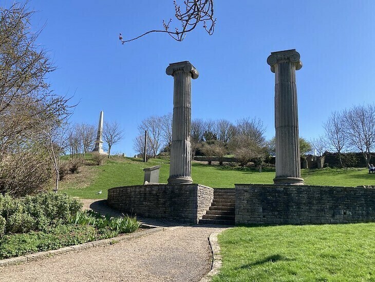 Two ornate pillars in a park