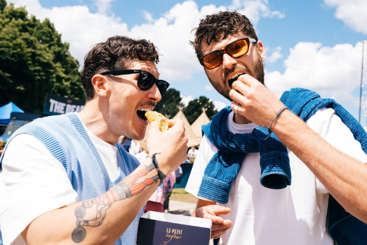 Two men eating at Taste of London festival