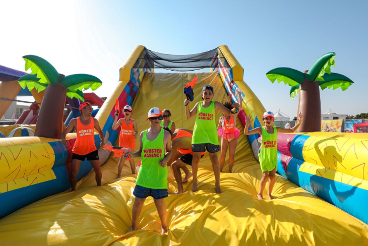 A group of people on a giant inflatable obstacle course