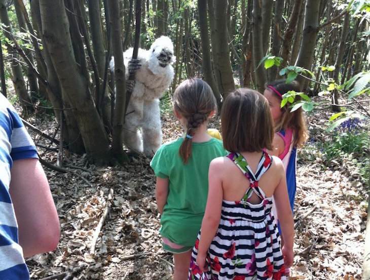 Visit Sevenoaks: a group of three children facing a yeti in a forest