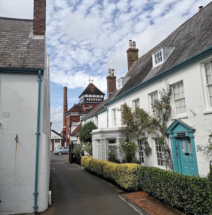 Visit Lewes: a row of white-washed cottages next to the Harvey's Brewery in Lewes