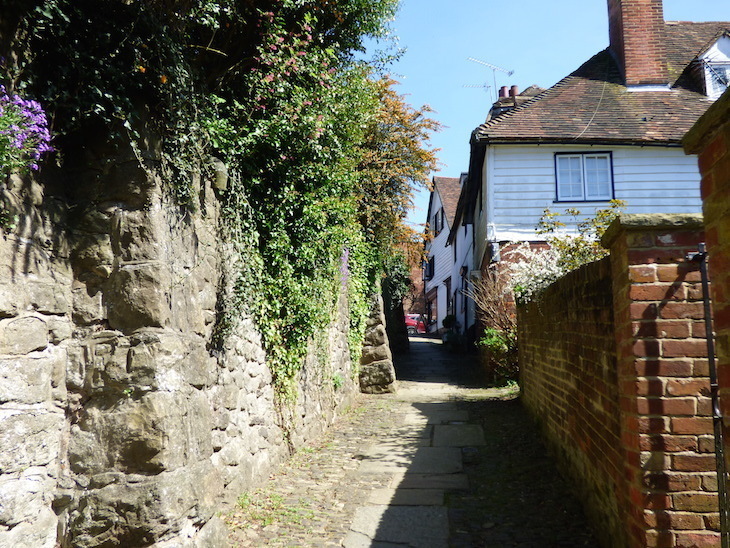 Visit Sevenoaks: a paved pathway up a hill with a row of cottages on one side
